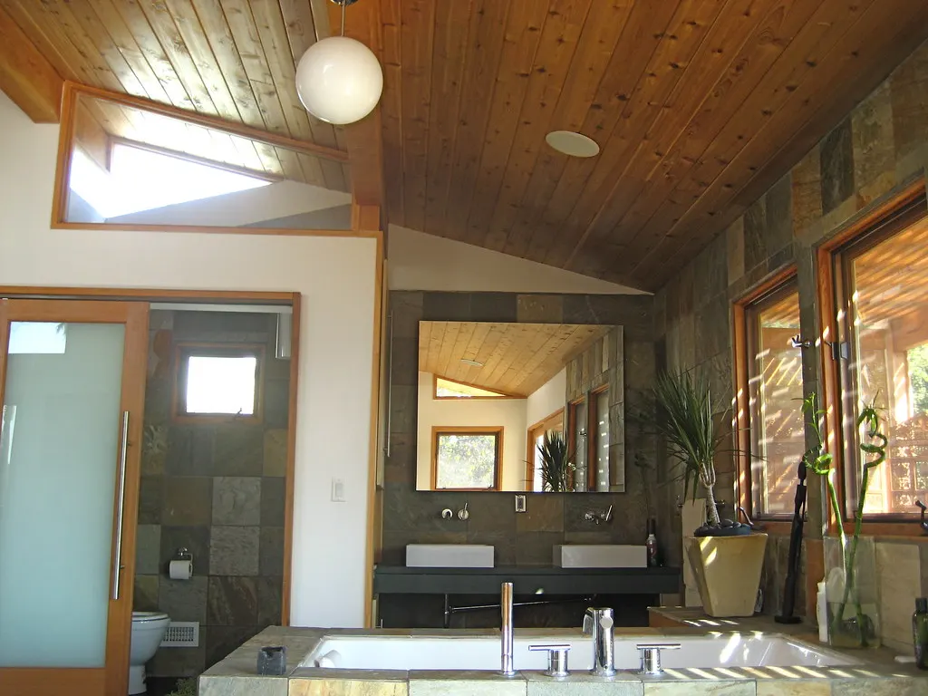 Remodeled bathroom with a modern vanity and wood ceiling