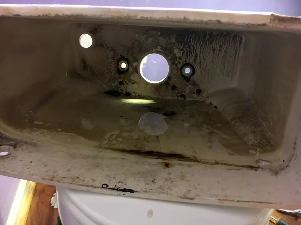 Inside of an empty toilet tank