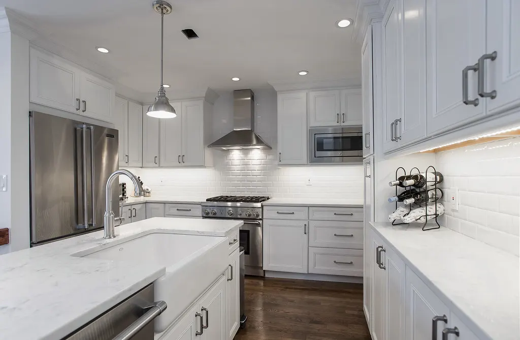 Remodeled white kitchen with stainless steel appliances