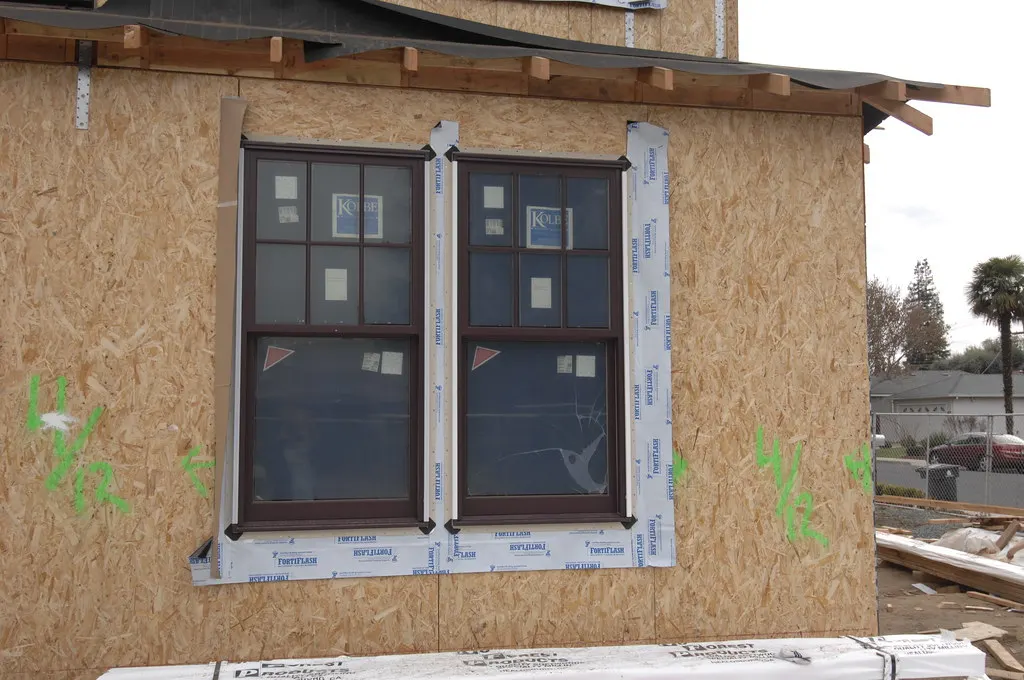 New double-hung windows installed in a house wall